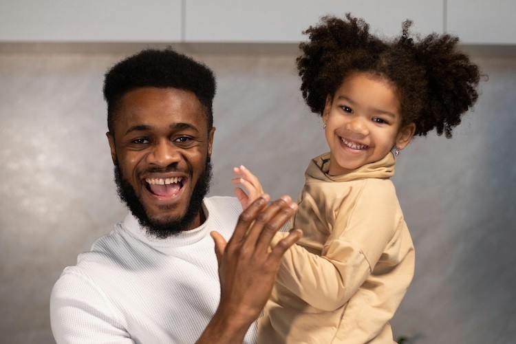 father holding preschool-age child