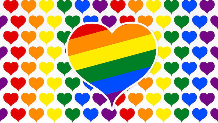 Rainbow heart superimposed over rows of smaller hears in Pride colors